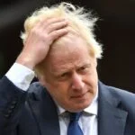 Image of Boris Johnson with his hand on his head